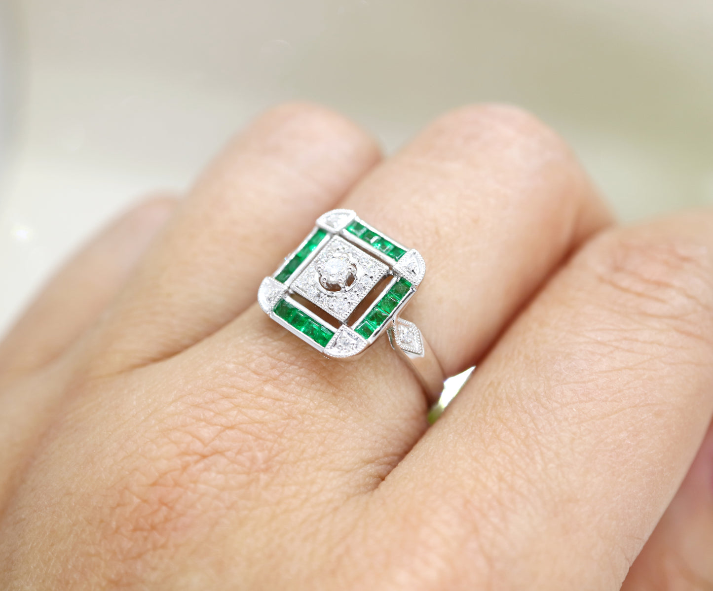 Art deco emerald ring in square channel set design