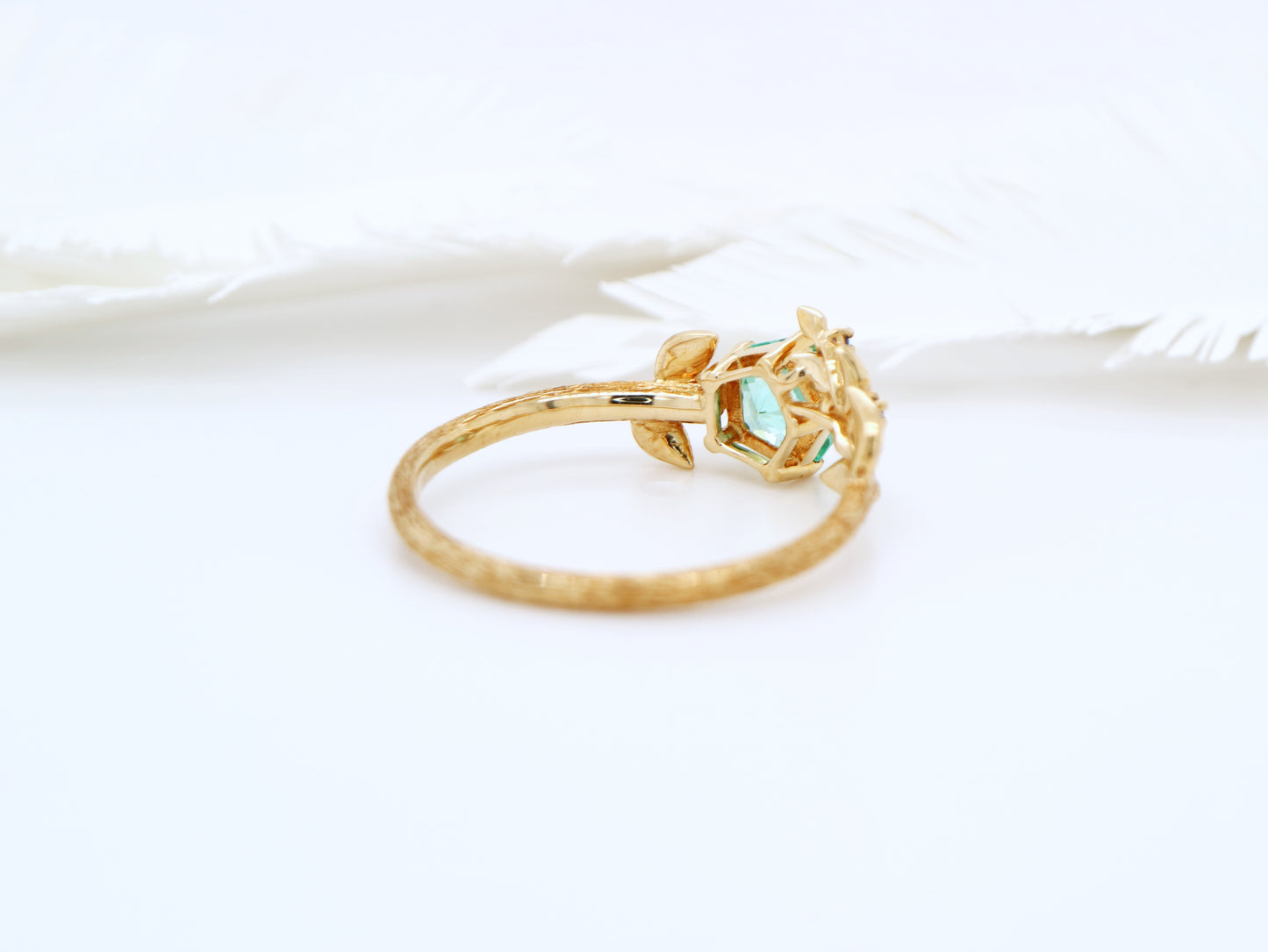 Teal sapphire Hanami ring set in golden leaf and twig design