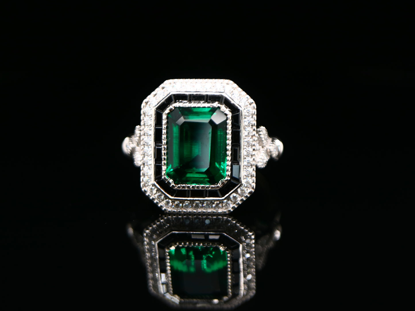 Art deco style emerald ring with black onyx channel set halo