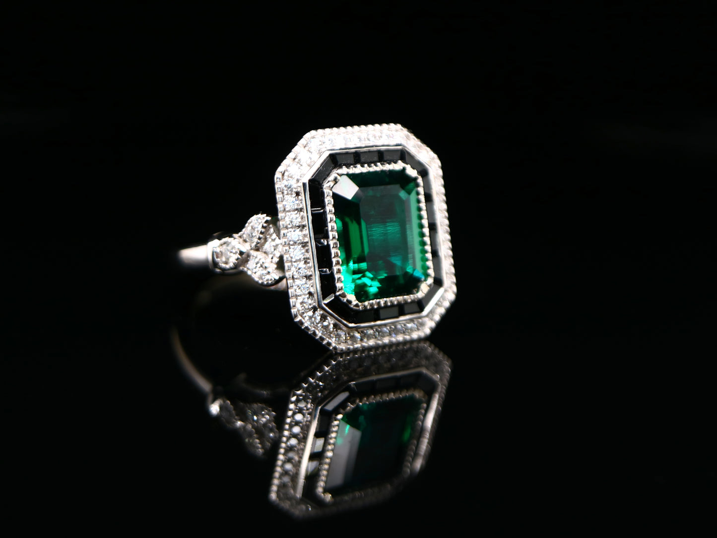 Art deco style emerald ring with black onyx channel set halo