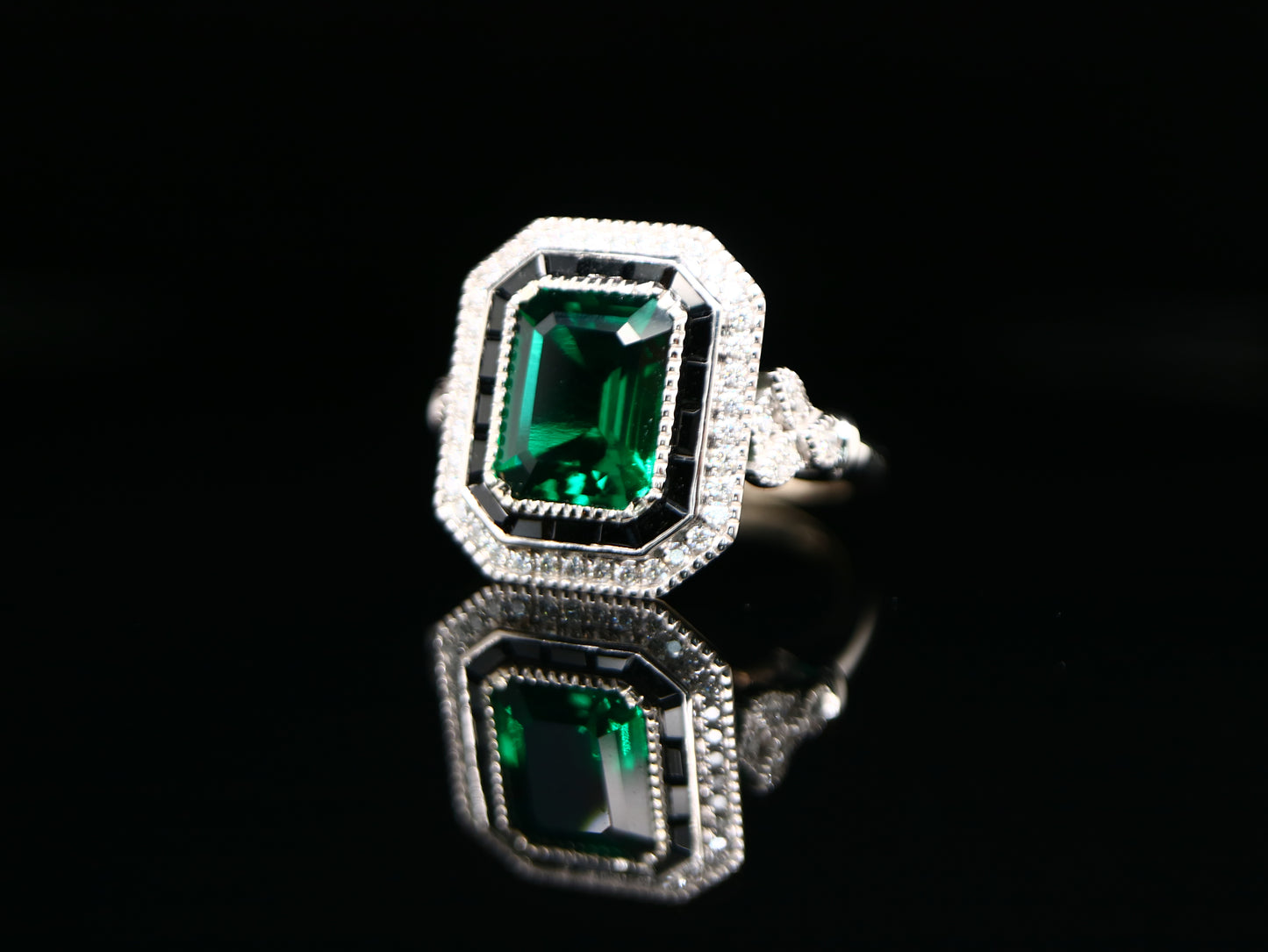 Art deco style emerald ring with black onyx channel set halo