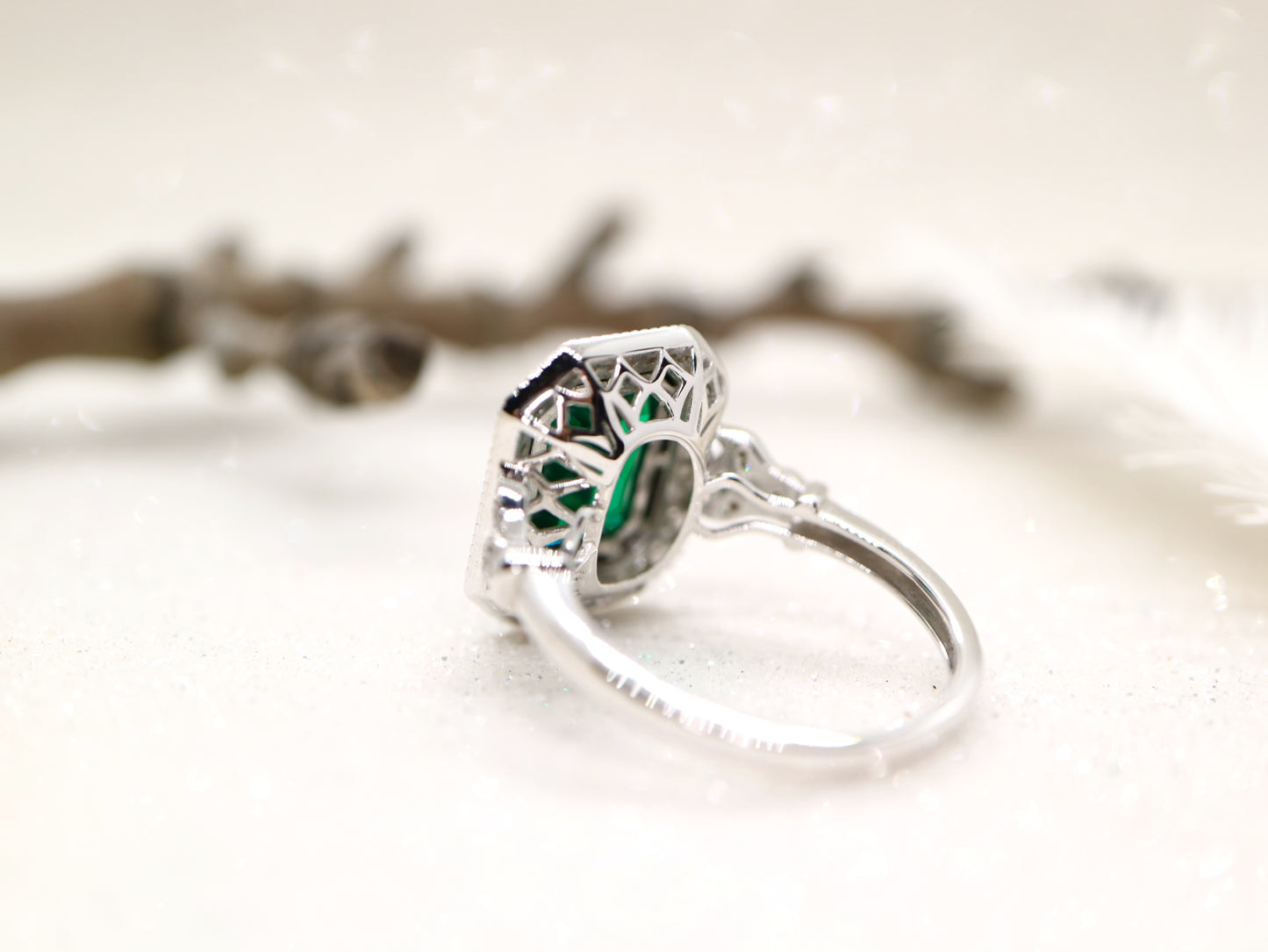 Art deco style emerald ring with black onyx channel set halo