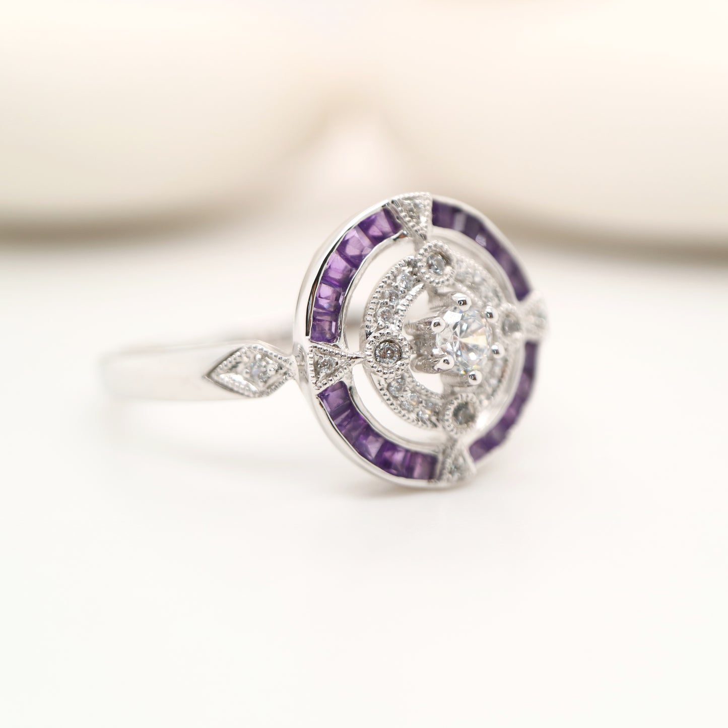 Art Deco inspired white gold ring with diamond and amethyst halo