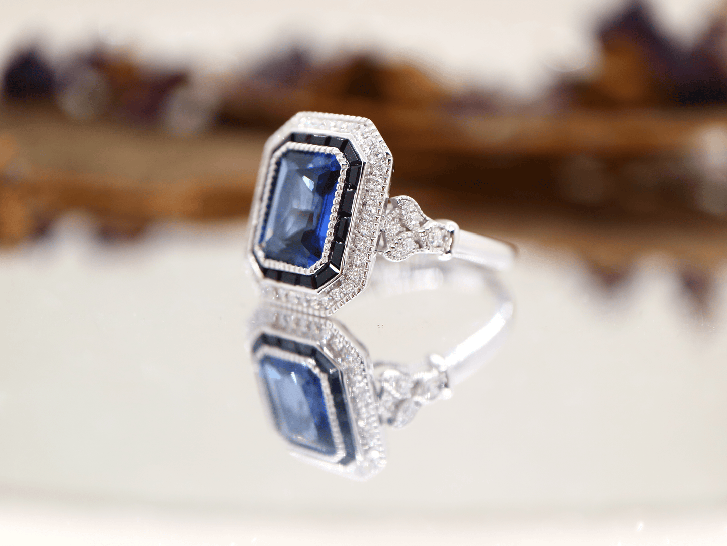 Art deco style blue sapphire ring with black onyx channel set halo