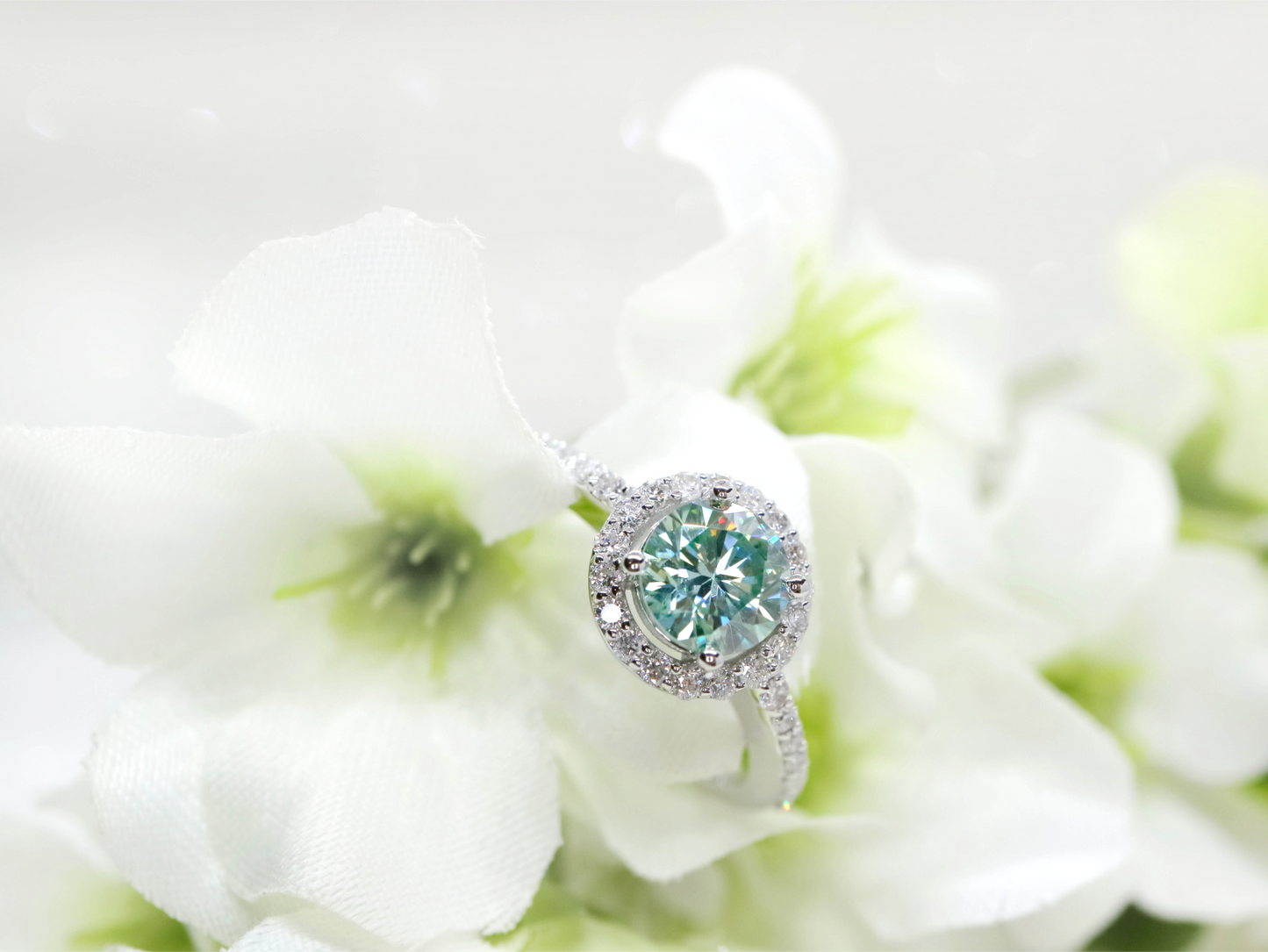 Minty green moissanite and diamond halo ring